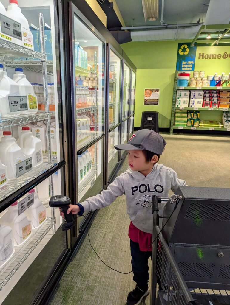 My kid at Discovery Market: Shopping with Tech exhibit